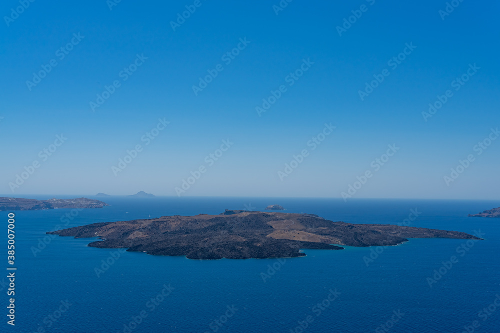 Beautiful panoramic view from Thira to caldera and volcano on a sunny day. Picturesque natural background with copy space for text. Santorini island, Cyclades, Greece, Europe. Beautiful panoramic view from Thira to caldera and volcano on a sunny day. Picturesque natural background with copy space for text. Santorini island, Cyclades, Greece, Europe.
