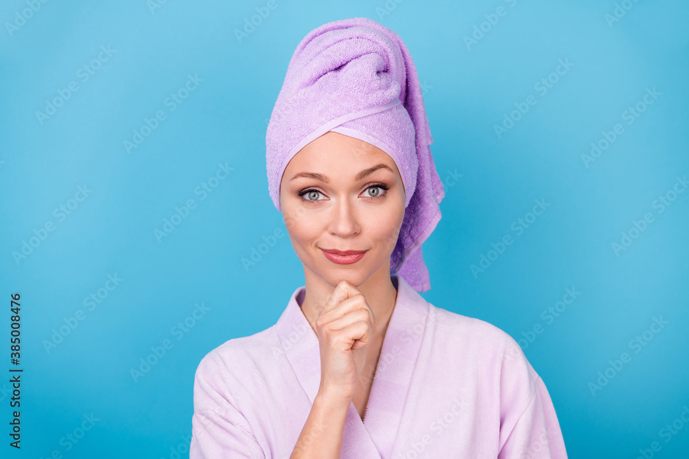 Photo of lovely lady finger chin look camera wear violet towel turban bath robe isolated blue color background Photo of lovely lady finger chin look camera wear violet towel turban bath robe isolated blue color background
