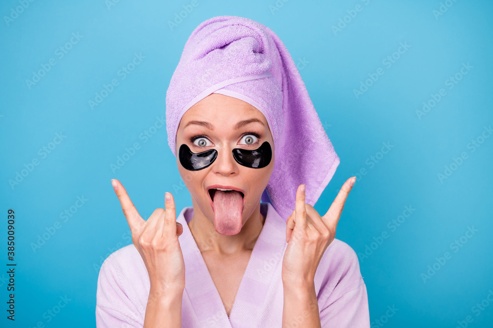 Photo of funky funny girl tongue-out show horns wear violet towel turban bath robe isolated blue color background - obrazy, fototapety, plakaty 
