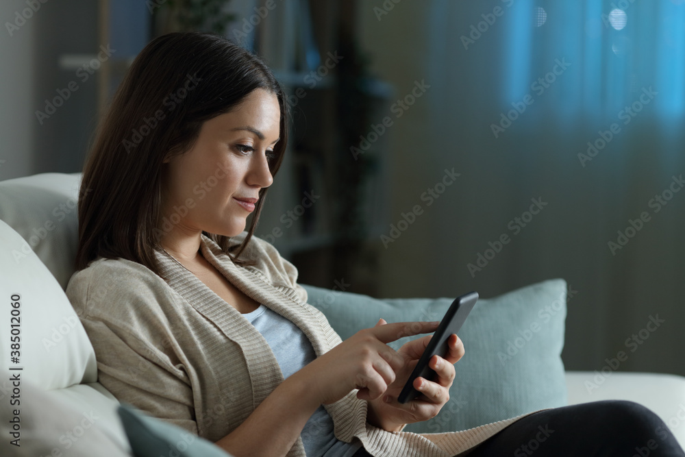 Woman using smart phone in the night at home Woman using smart phone in the night at home