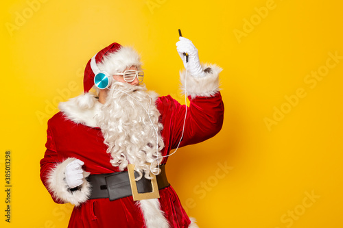 Santa Claus wearing headset and listening to the music