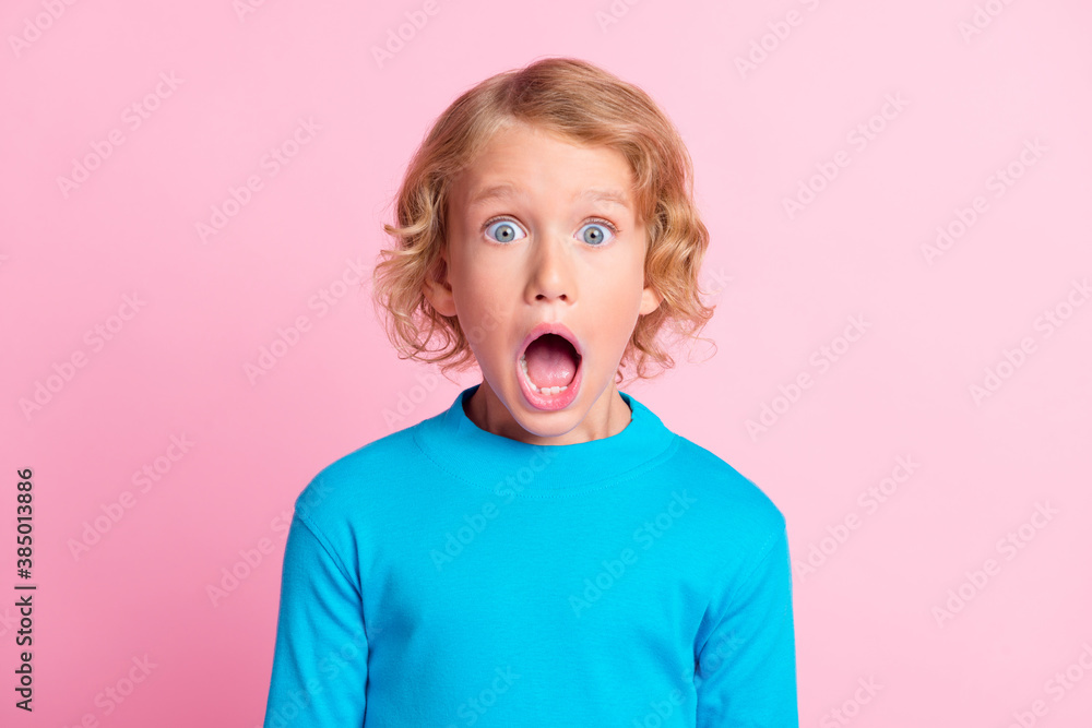 Photo of small kid unexpected open mouth wear blue turtleneck shirt isolated pastel pink color background Photo of small kid unexpected open mouth wear blue turtleneck shirt isolated pastel pink color background