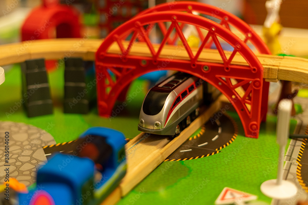 A toy tray set with the train passing under a tunnel using selective focus