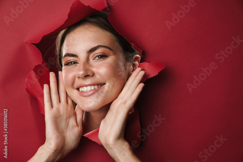 Caucasian young happy woman raising hands and smiling at camera