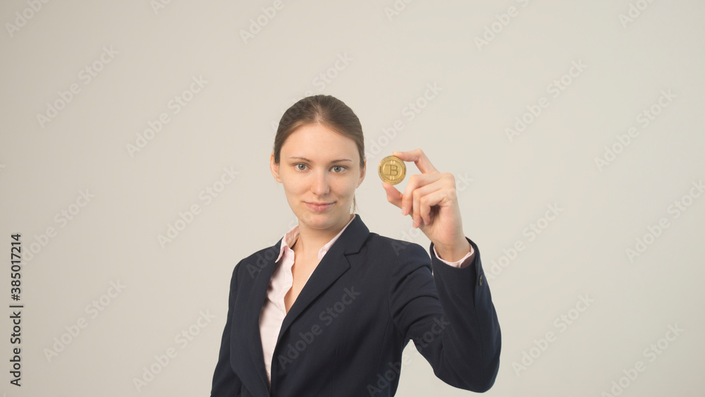 Woman holding a physical bitcoin cryptocurrency in her hand Woman holding a physical bitcoin cryptocurrency in her hand