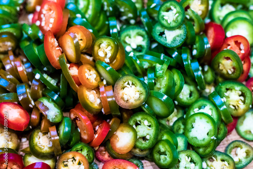 Pile of colourful ripe jalapenos cuts ready for cooking and preservation.