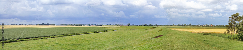 Extremely flat polder landscape with a dike, in the Netherlands