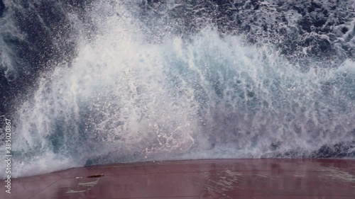 Wave splashing against the board of the ship.