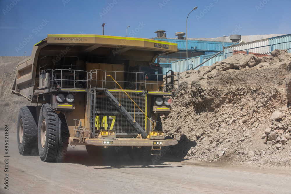 Huge dump trucks working the Chuquicamata open pit copper mine, the largest by volume in the world, Chile Huge dump trucks working the Chuquicamata open pit copper mine, the largest by volume in the world, Chile