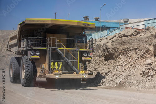 Huge dump trucks working the Chuquicamata open pit copper mine, the largest by volume in the world, Chile photo