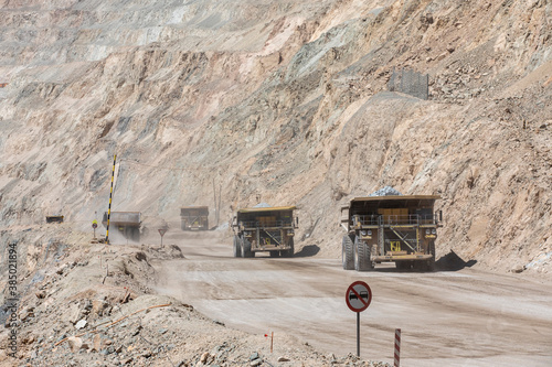 Huge dump trucks working the Chuquicamata open pit copper mine, the largest by volume in the world, Chile photo