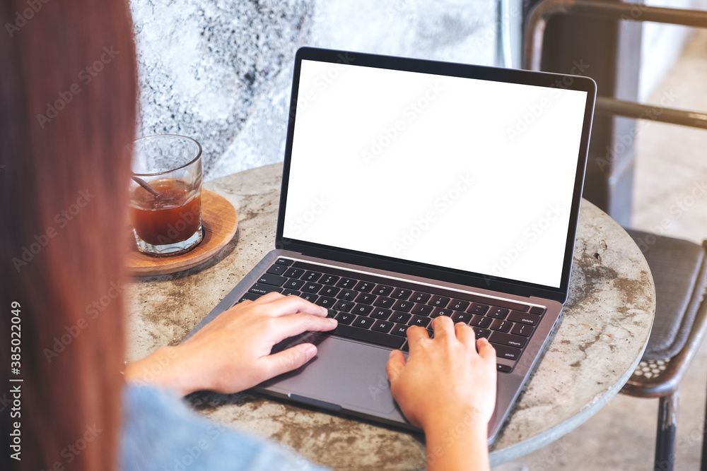 Mockup image of a woman using and typing on laptop computer keyboard with blank white desktop screen Mockup image of a woman using and typing on laptop computer keyboard with blank white desktop screen