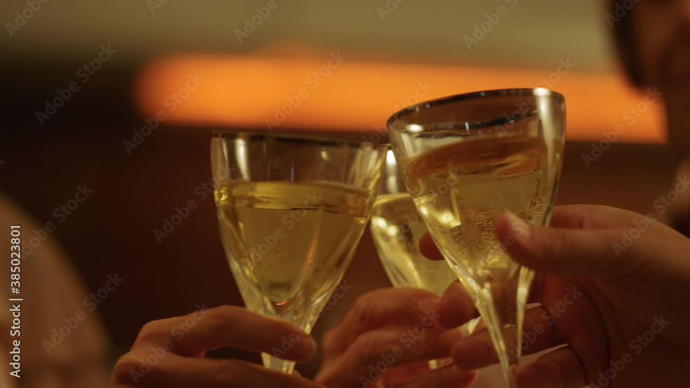 Family hands holding wine glasses in hands. People toasting with wine in glasses