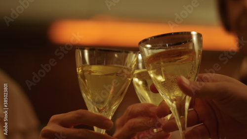 Family hands holding wine glasses in hands. People toasting with wine in glasses