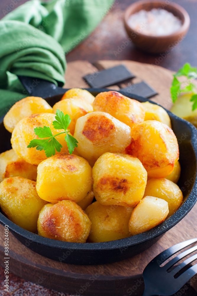 Whole potatoes fried in a pan, pushkin potatoes, selective focus Whole potatoes fried in a pan, pushkin potatoes, selective focus