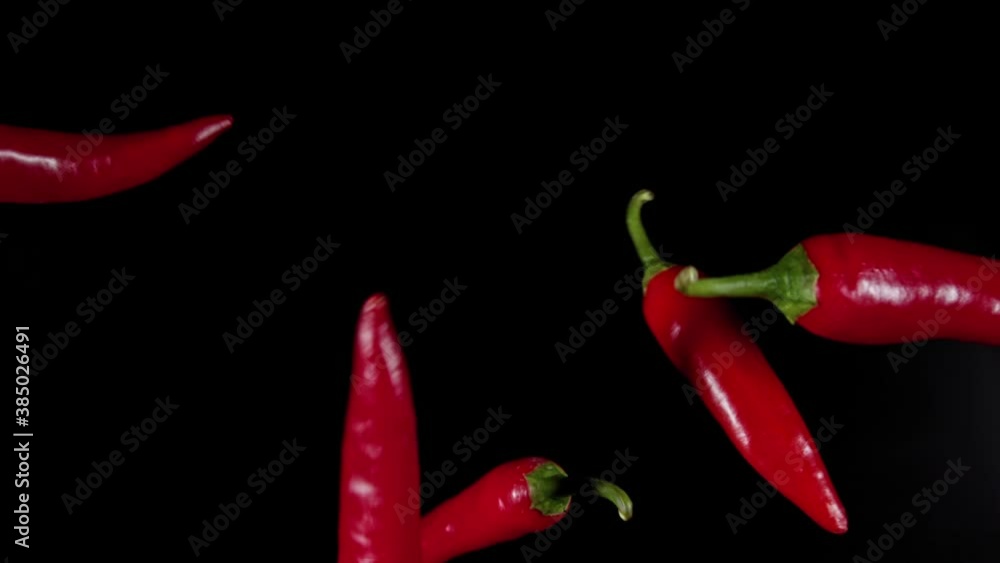 Slow Motion Shot of Flying Red Chilli Peppers in the Air Slow Motion Shot of Flying Red Chilli Peppers in the Air