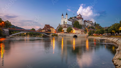 Aarburg, Switzerland. Panoramic cityscape image of beautiful city of Aarburg with the reflection of the city in the Aare river at sunset.