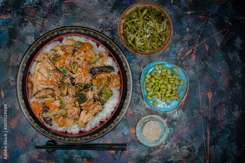 Vegan chirashizushi  made with yuba, shiitake, broccoli and pepper in traditional bowl along with wakame, edamame.