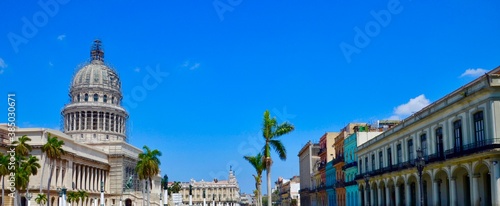 Havana, Cuba, multicolored colonial houses, Capitol, blue sky background, palm trees