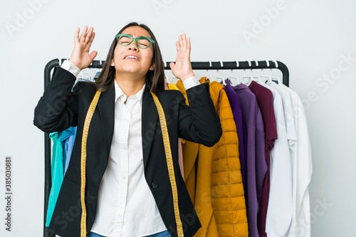 Young asian designer woman isolated on white background screaming to the sky, looking up, frustrated.
