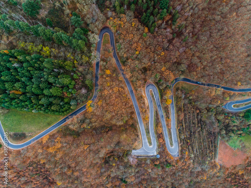 Seasons Concept winter or fall Aerial view Winding road serpentine mountain pass village Brodenbach Germany photo