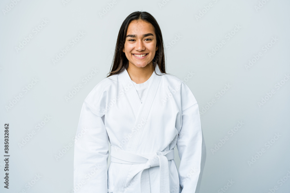 Young asian woman doing karate isolated on white background happy, smiling and cheerful. Young asian woman doing karate isolated on white background happy, smiling and cheerful.