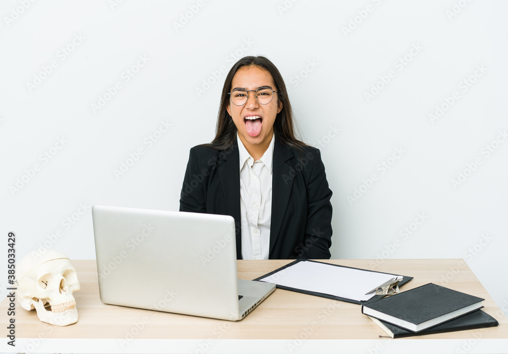 Young traumatologist asian woman isolated on white background funny and friendly sticking out tongue. Young traumatologist asian woman isolated on white background funny and friendly sticking out tongue.