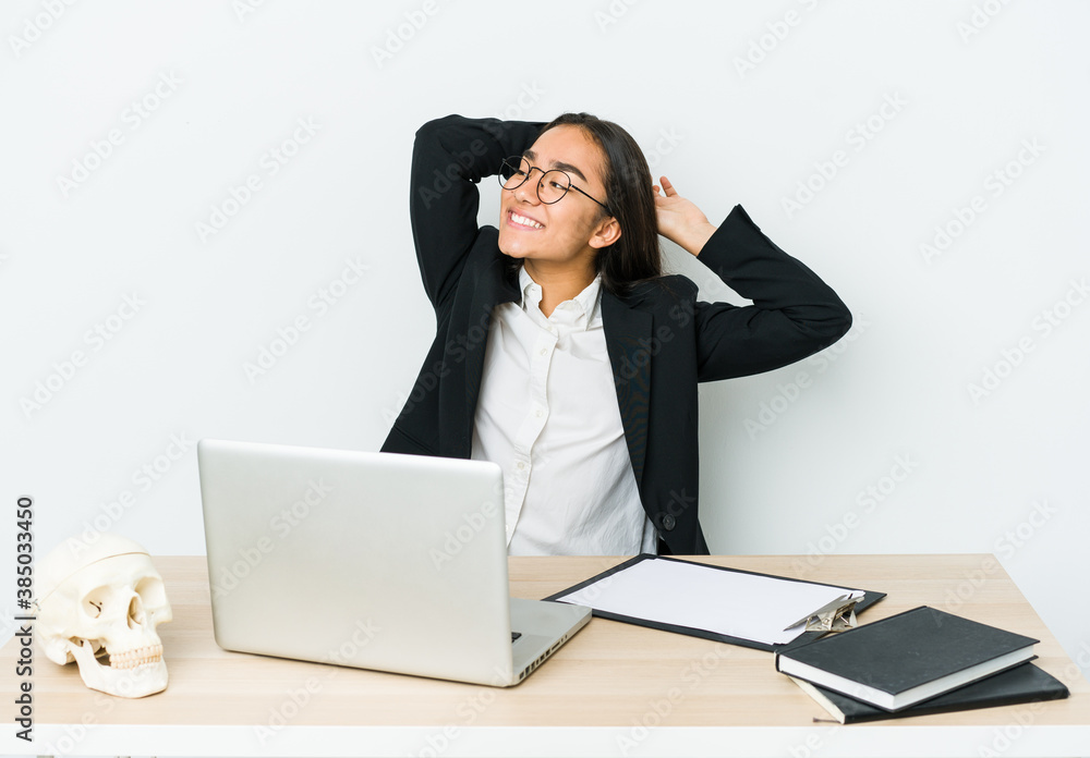 Young traumatologist asian woman isolated on white background stretching arms, relaxed position. Young traumatologist asian woman isolated on white background stretching arms, relaxed position.