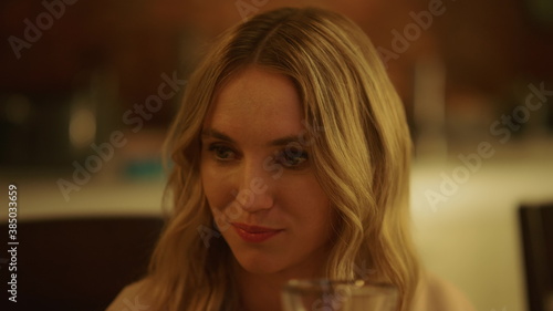 Woman making toast during festive dinner. Attractive lady talking with family