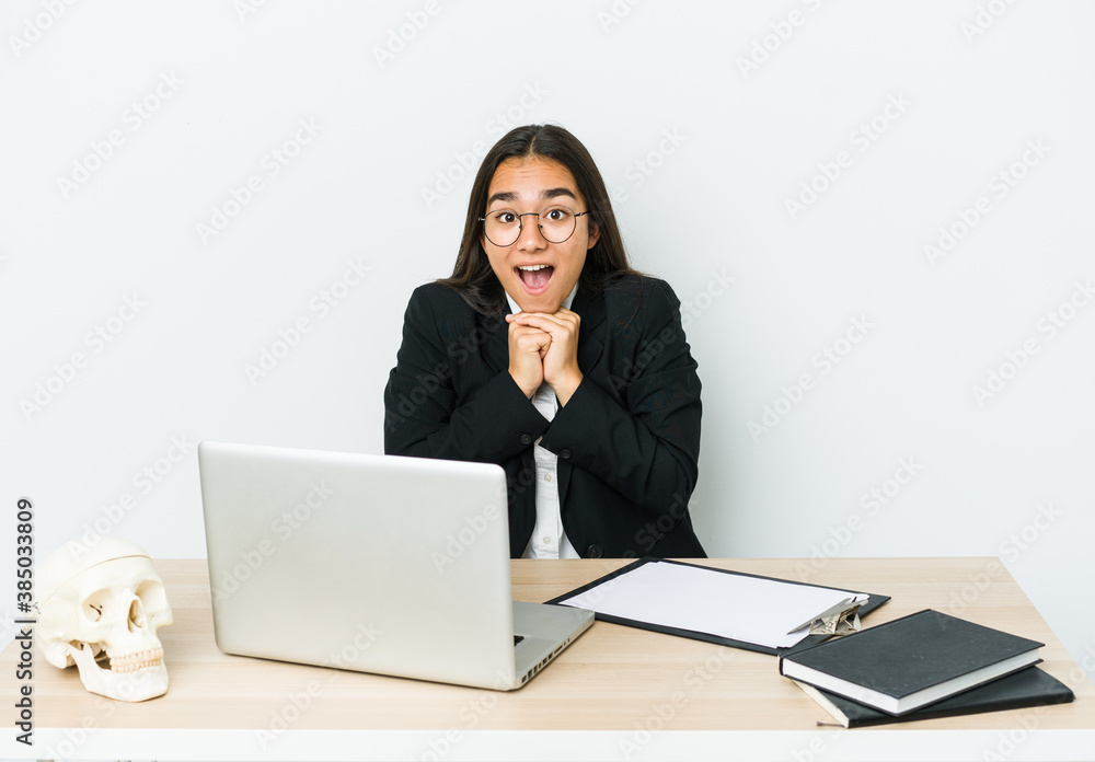 Young traumatologist asian woman isolated on white background praying for luck, amazed and opening mouth looking to front. Young traumatologist asian woman isolated on white background praying for luck, amazed and opening mouth looking to front.