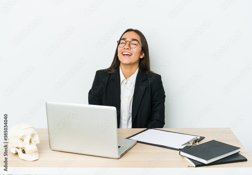 Young traumatologist asian woman isolated on white background relaxed and happy laughing, neck stretched showing teeth. Young traumatologist asian woman isolated on white background relaxed and happy laughing, neck stretched showing teeth.