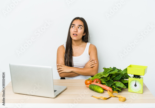 Young dietician asian woman isolated on white backgroun tired of a repetitive task.