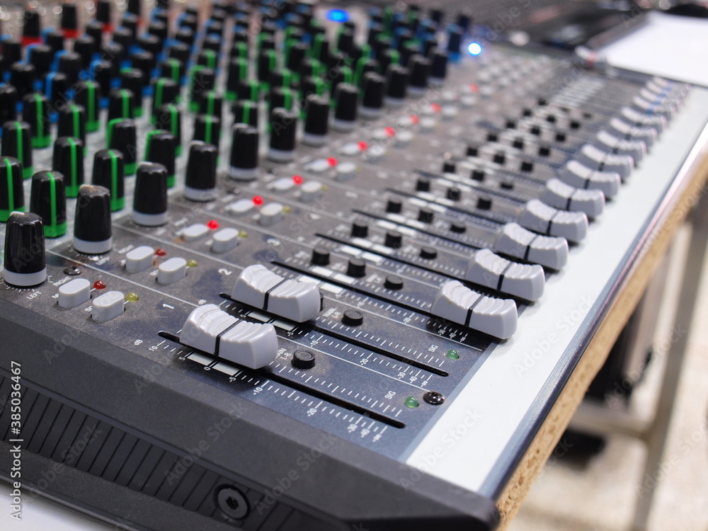 Mixer equipment is dirty with dust. The sound control mixer in use has nasty dust. Focus closely and choose the subject.