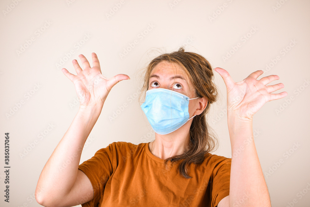 Scared woman in medical mask covers her face with her hands, isolated on white background Scared woman in medical mask covers her face with her hands, isolated on white background