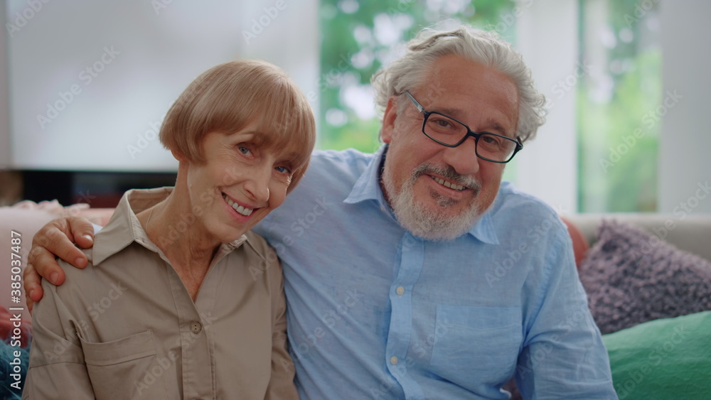 Smiling senior man and woman looking at camera. Husband hugging wife Smiling senior man and woman looking at camera. Husband hugging wife