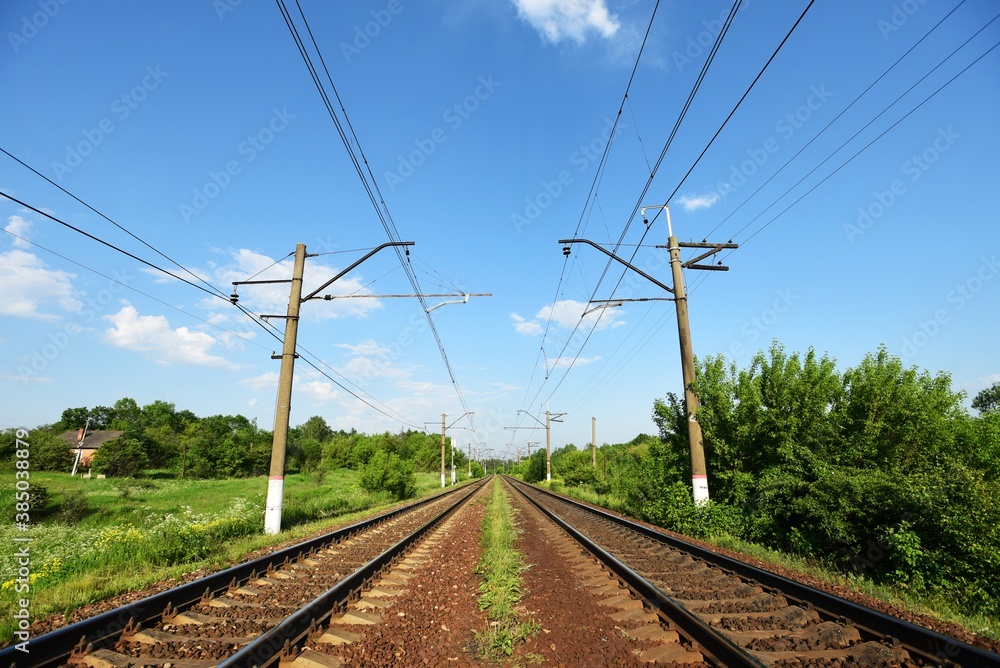 empty straight railway on a sunny summer day, country landscape