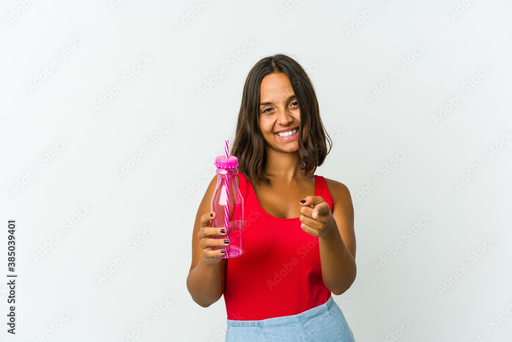 Young latin woman holding a milkshake isolated on white background Young latin woman holding a milkshake isolated on white background