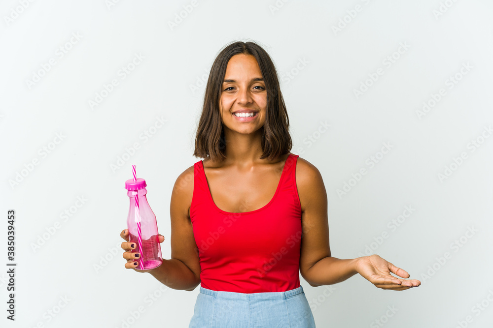 Young latin woman holding a milkshake isolated on white background Young latin woman holding a milkshake isolated on white background