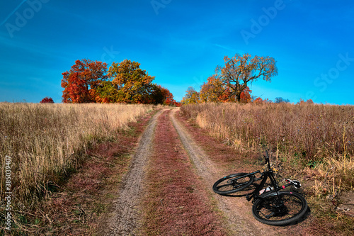 Outdoor cycling. Mountain bike in wild nature landscape background. Panoramic landscape of central Russia agricultural countryside with hill.