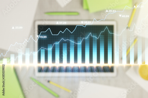 Multi exposure of abstract creative financial chart and digital tablet on background, top view, research and analytics concept © Pixels Hunter