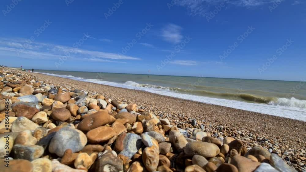 Waves crash onto a stone beach Waves crash onto a stone beach