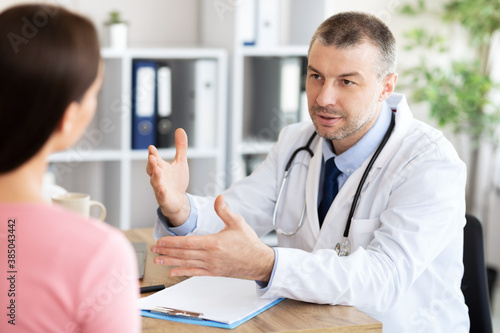 Male experienced doctor talking to his patient