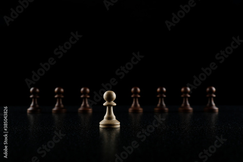 row of chess pieces on black background