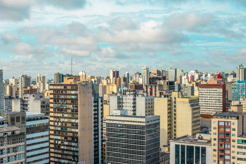 Aerial view landscape of urbanized center with colorful buildings and blue sky with white clouds - Curitiba, capital of Paraná state, Brazil