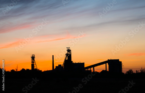 Old mine against the backdrop of a beautiful sunset photo