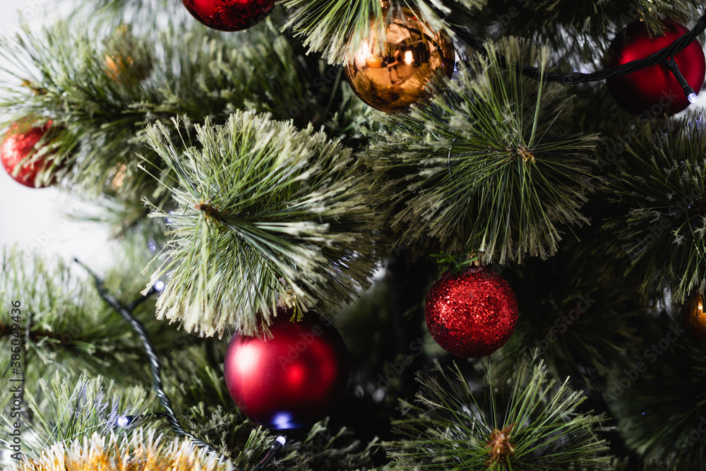 Fototapeta premium Close up view of pine with christmas balls and lights