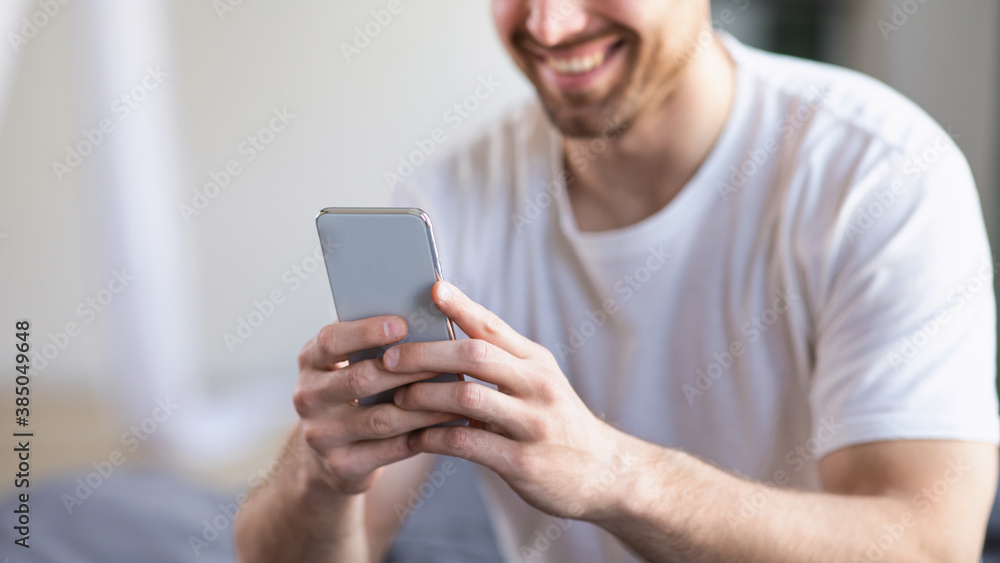 Unrecognizable Man Using Smartphone Mobile App Sitting In Bedroom, Panorama Unrecognizable Man Using Smartphone Mobile App Sitting In Bedroom, Panorama