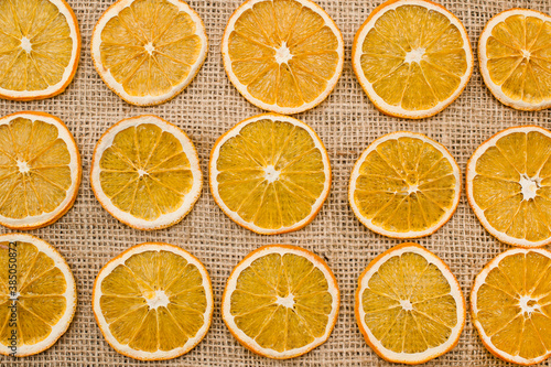 Dried Orange slices on linen cloth. Christmas decoration. Advent ornaments. Ethnographic ornamentation background