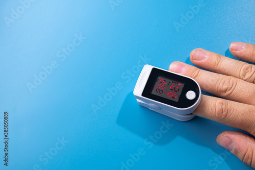 White new pulse oximeter on a blue table