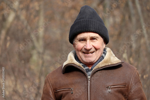 Portrait of happy elderly man outdoor. Autumn season, concept of old age, life in village © Oleg